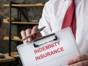 A man offers a indemnity insurance form for a signature