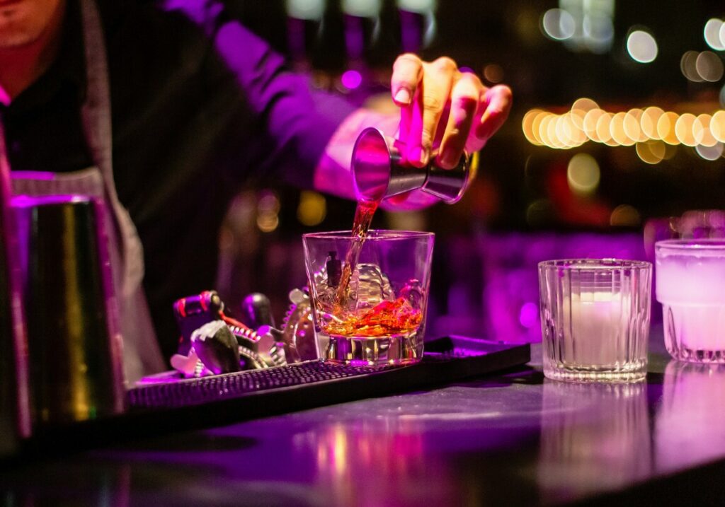 pouring a drink in a bar