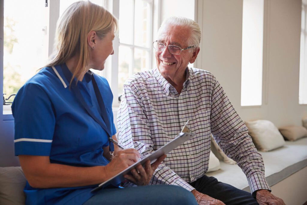 elderly man and nurse in care home